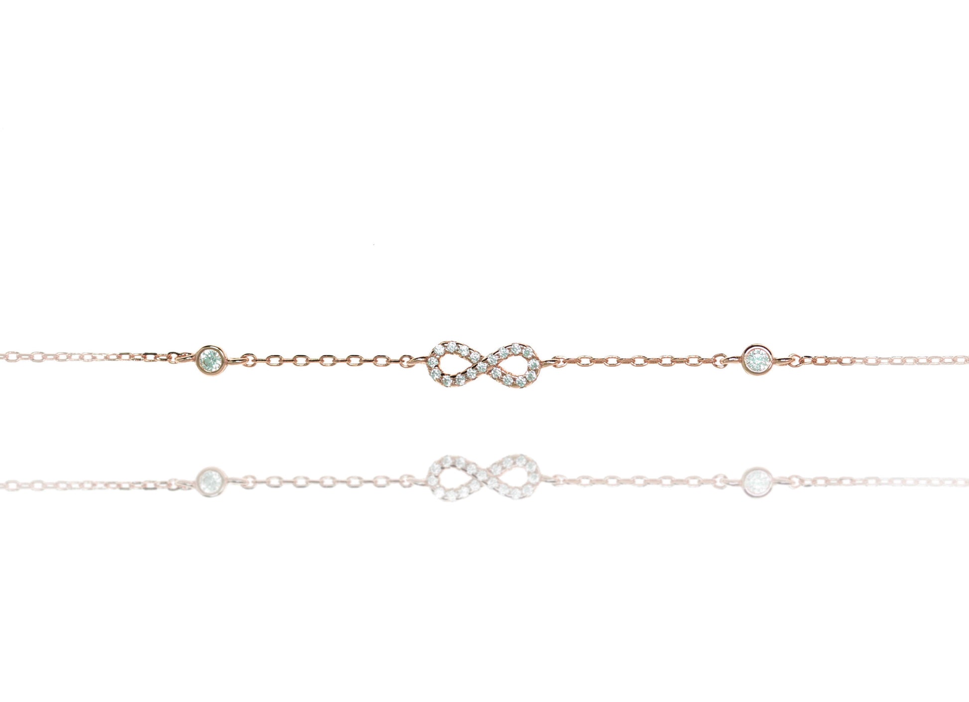 
Sterling silver chain bracelet with a white evil eye and cubic zirconia stones.

