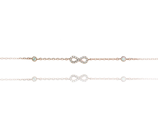 
Sterling silver chain bracelet with a white evil eye and cubic zirconia stones.

