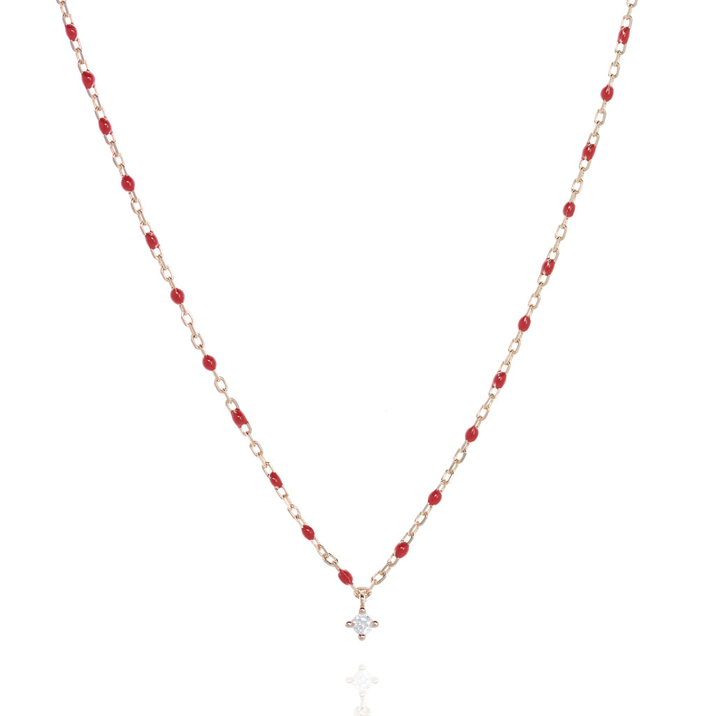 
Rose gold plated sterling silver short necklace with red beads and central Cubic Zirconia gem.

